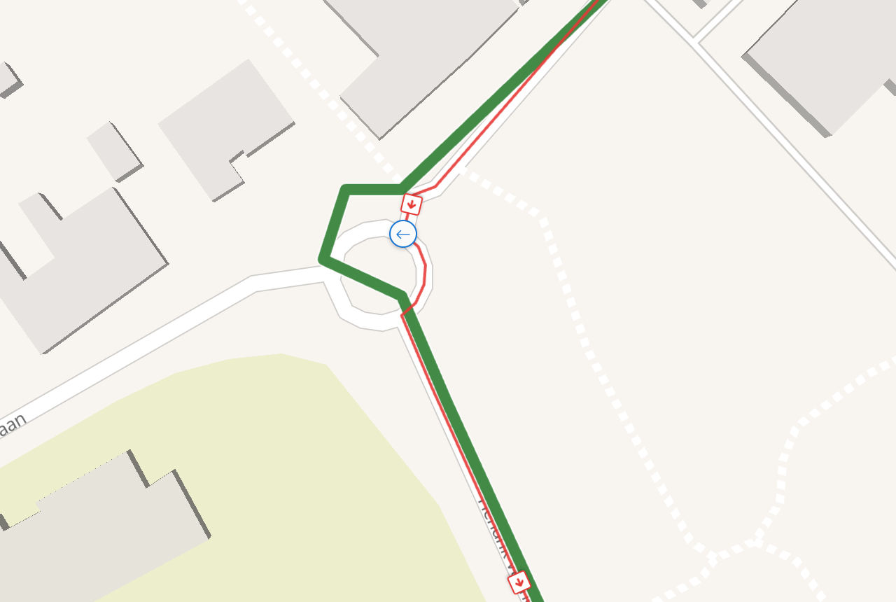A small Belgian roundabout. The wide green recorded line goes the long way round the west side; the thin red matched line cuts down the east side instead, against the direction of traffic