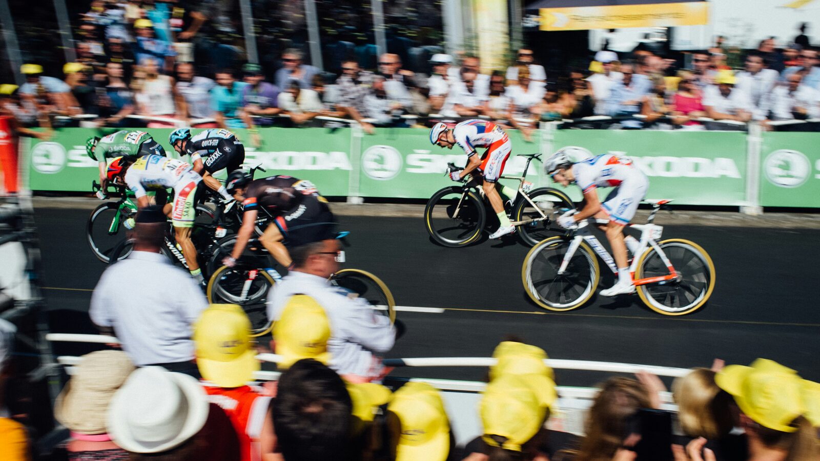 The Tour de France peloton racing past crowds