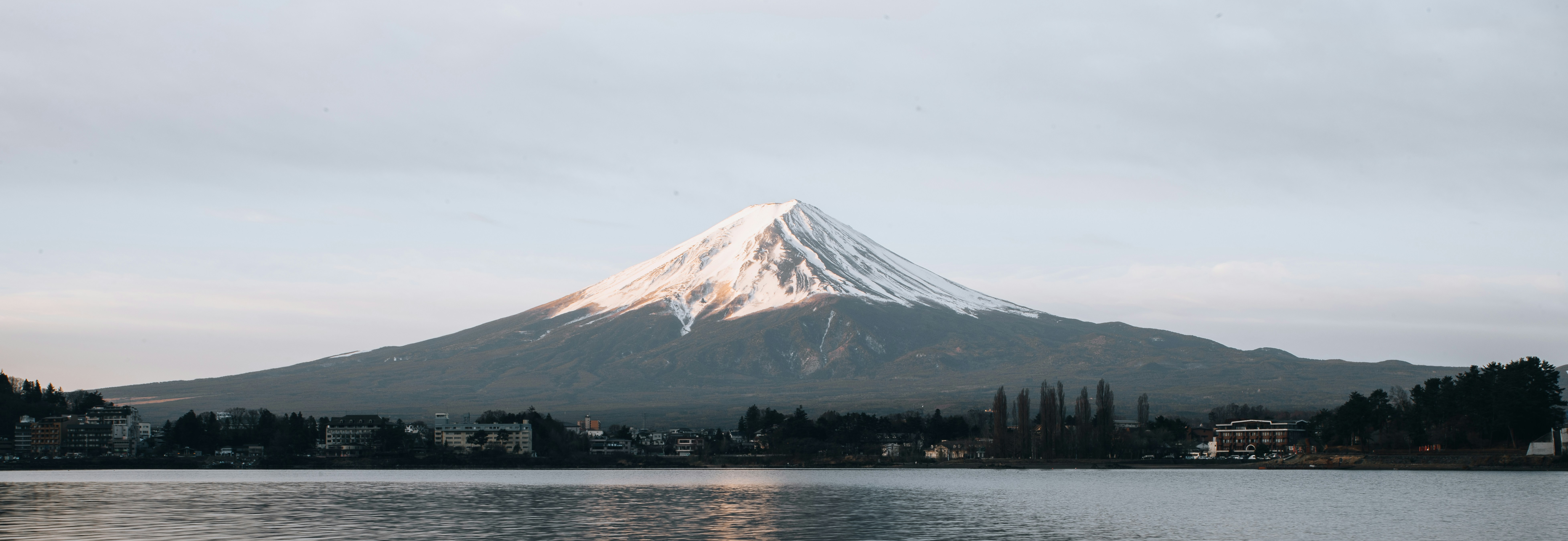 Mount Fuji rising above low cloud at dawn