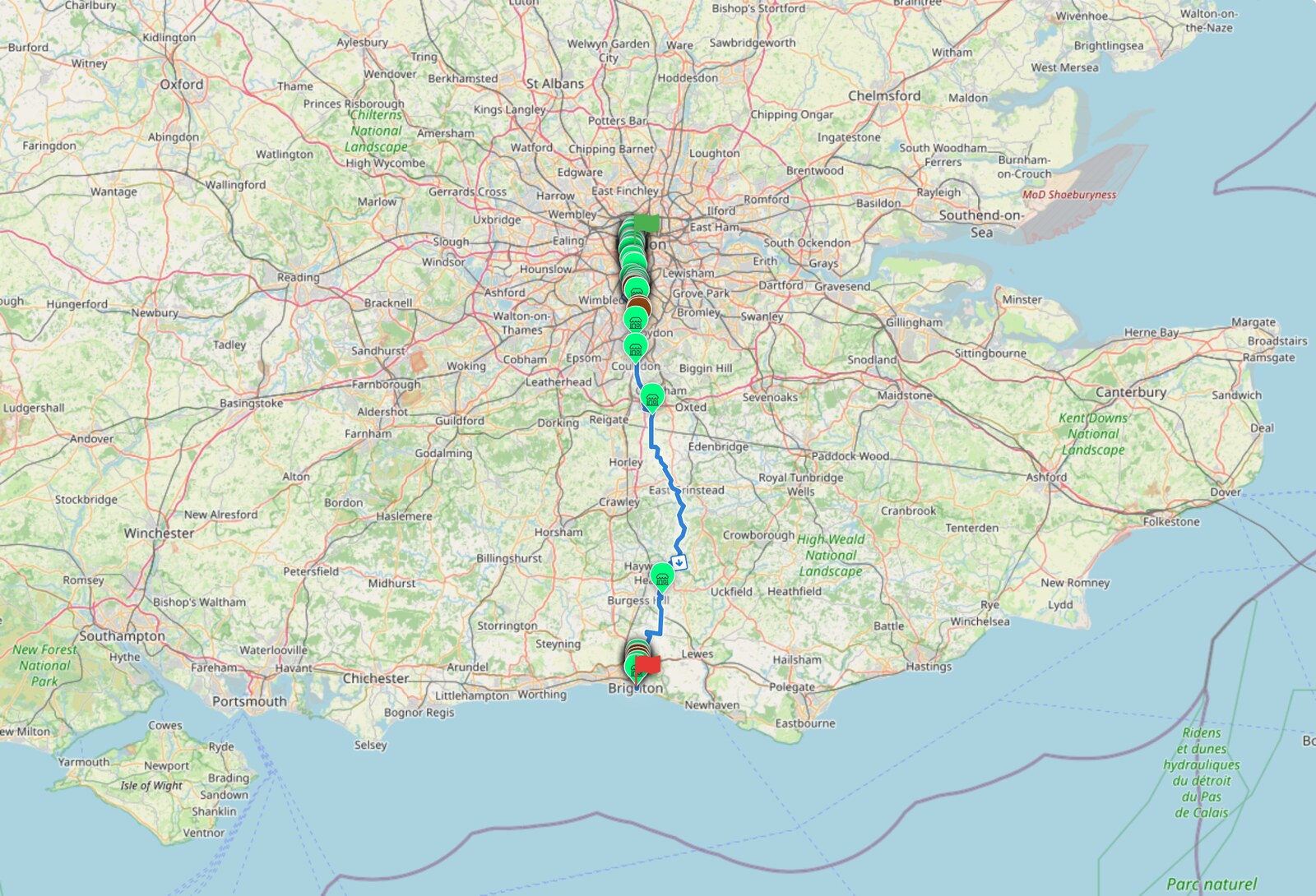 The full London to Brighton route with freezer-network POIs marked. Pins cluster thickly through London at the top and Brighton at the bottom, and thin out almost completely through the Surrey and Sussex countryside in the middle.